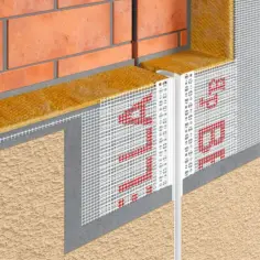 Dylatacja między budynkami, izolacja i siatka zbrojeniowa chroniąca elewację. Detal techniczny.