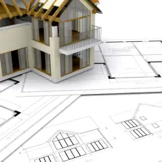 Model domu w trakcie budowy, leżący na planach architektonicznych. To kluczowy etap, czas budowy domu, od projektu do realizacji.
